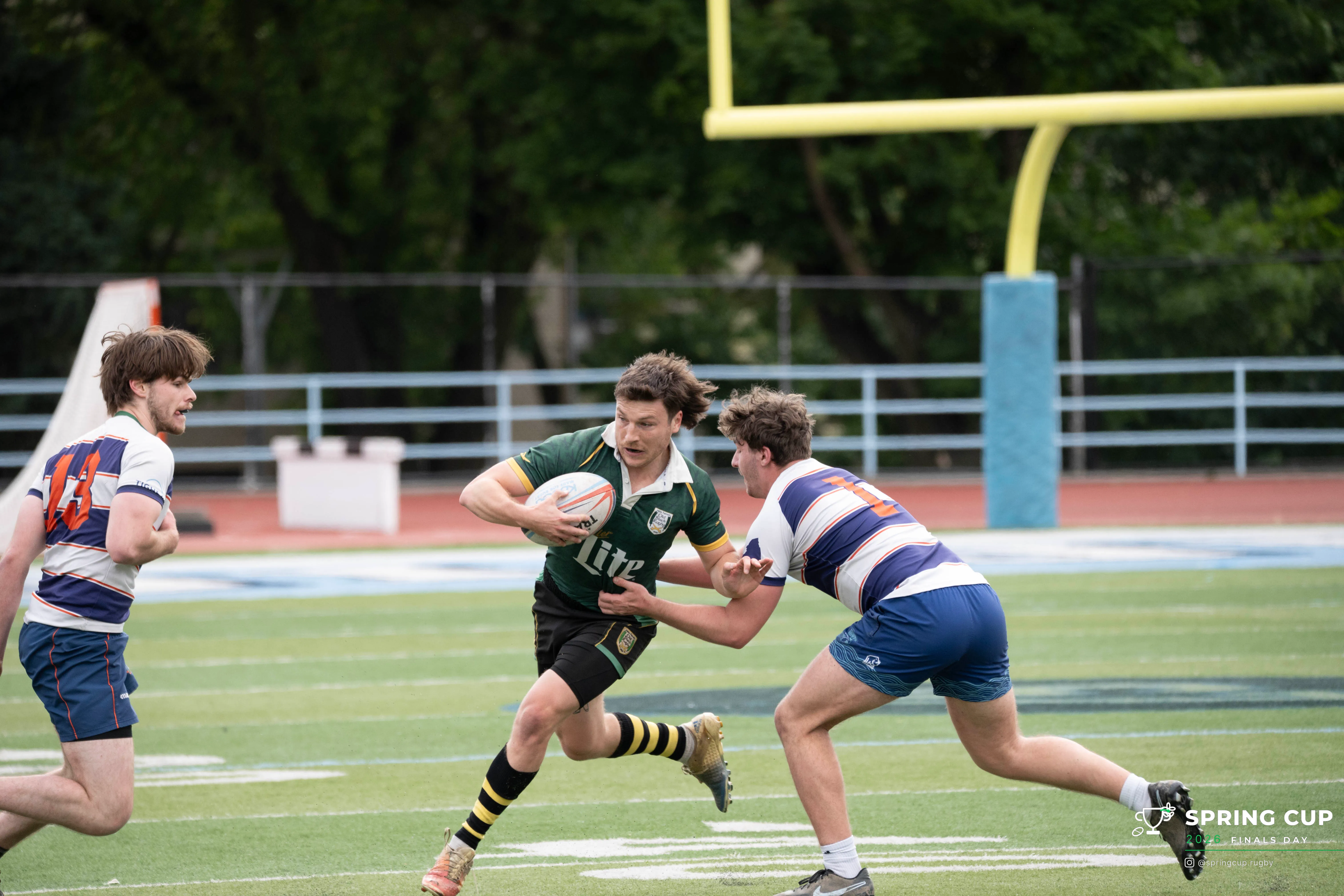 A New Haven Old Black player breaks a tackle on a run to the line